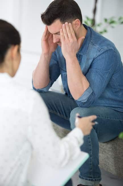 professional interventionist speaks with a client about substance abuse during drug addiction intervention services