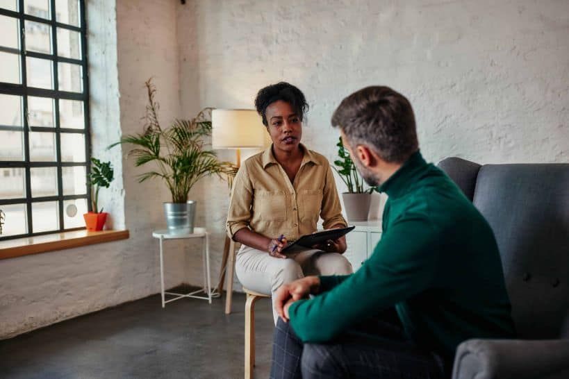 man talks with his counselor during outpatient program at Inner Voyage Recovery