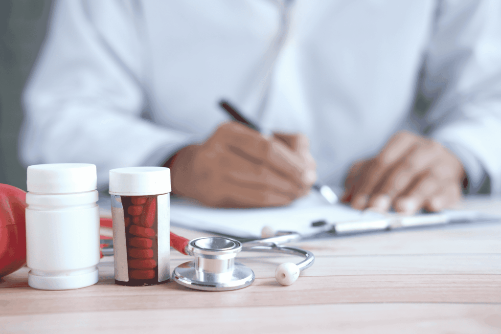Doctor's desk with medication bottles, pills, and a stethoscope for addiction treatment.