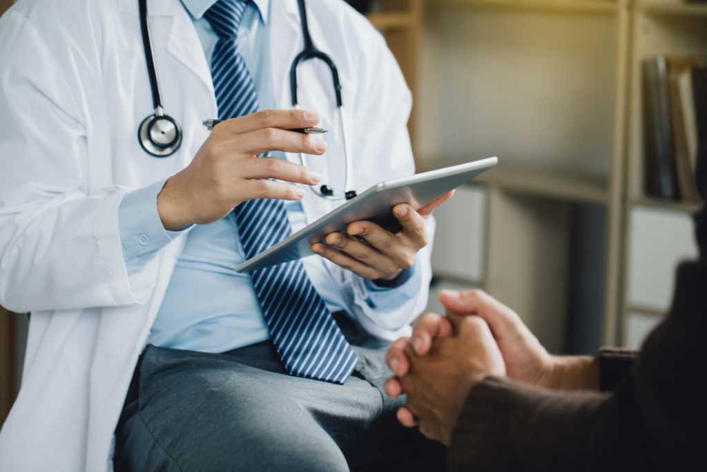 Doctor using a tablet during a consultation at Inner Voyage Recovery Center.
