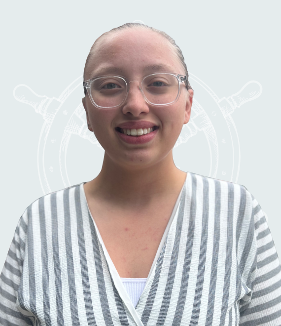 Smiling young woman with glasses in front of a nautical-themed background.