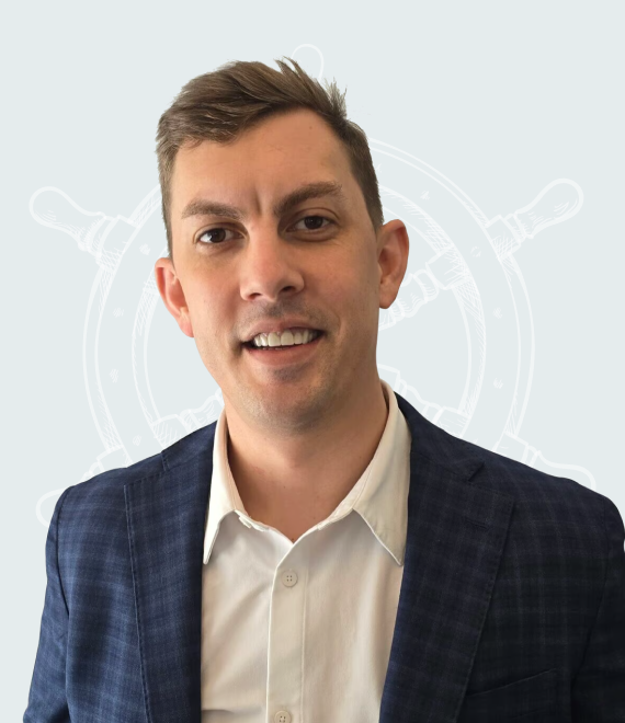 Professional man in a suit smiling against a nautical background.