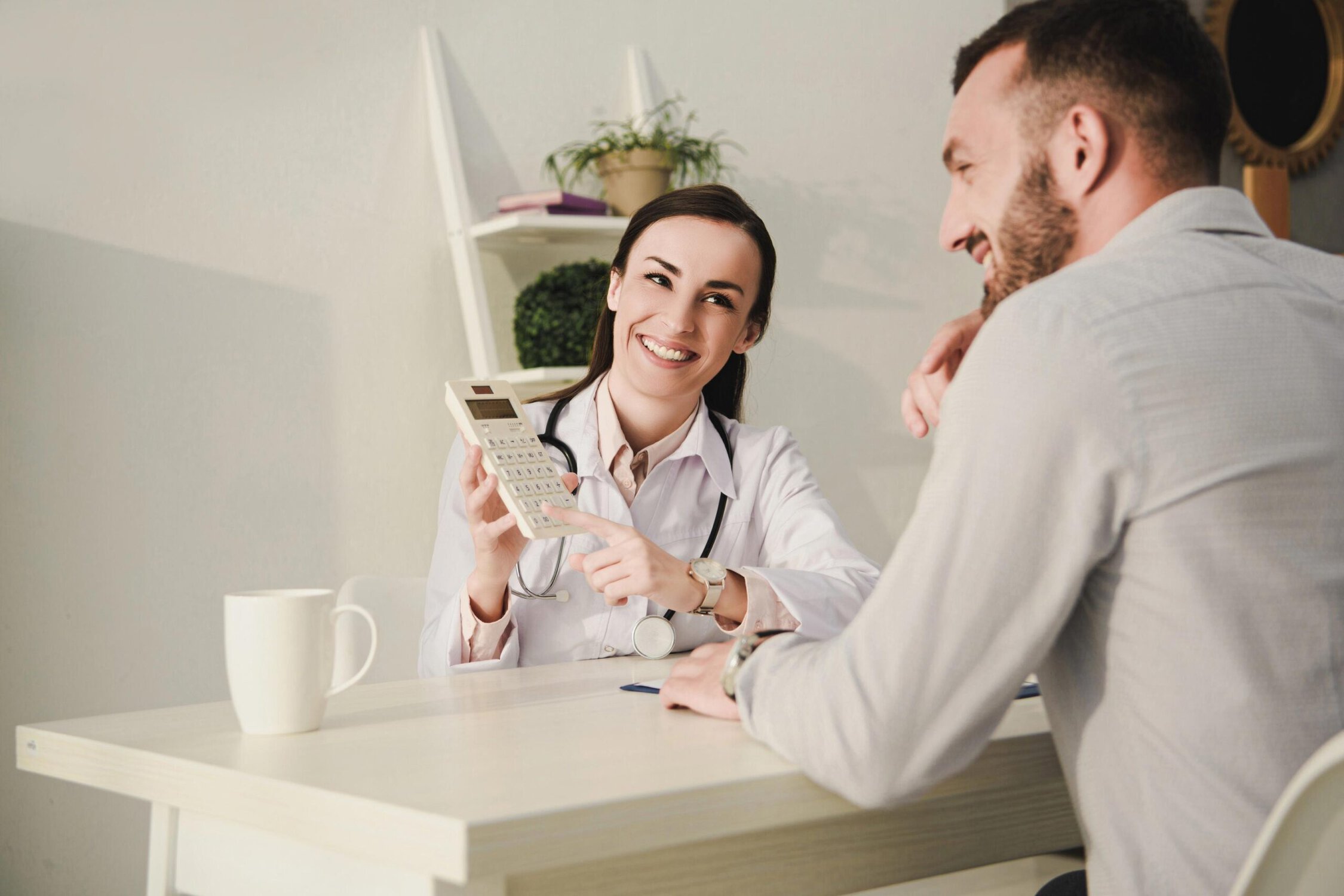 Medical professional consulting a patient in an office setting.